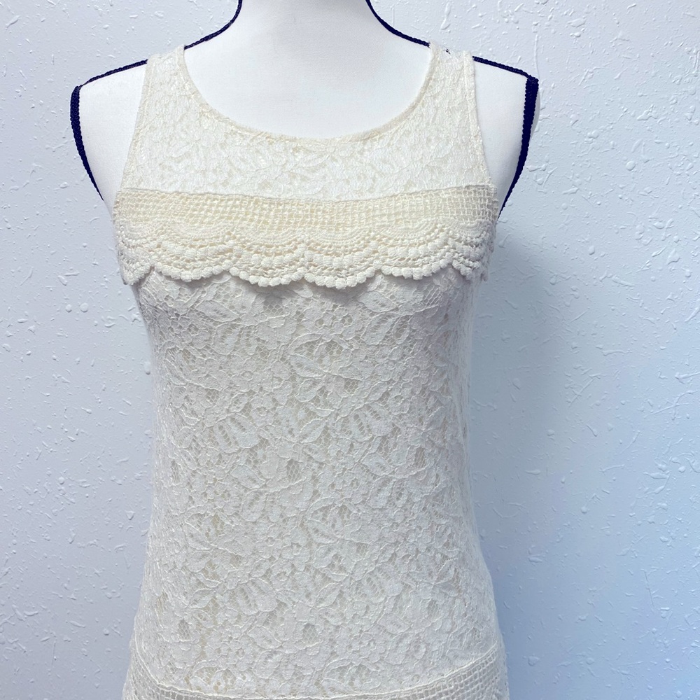 Cream colored lace detailed top.